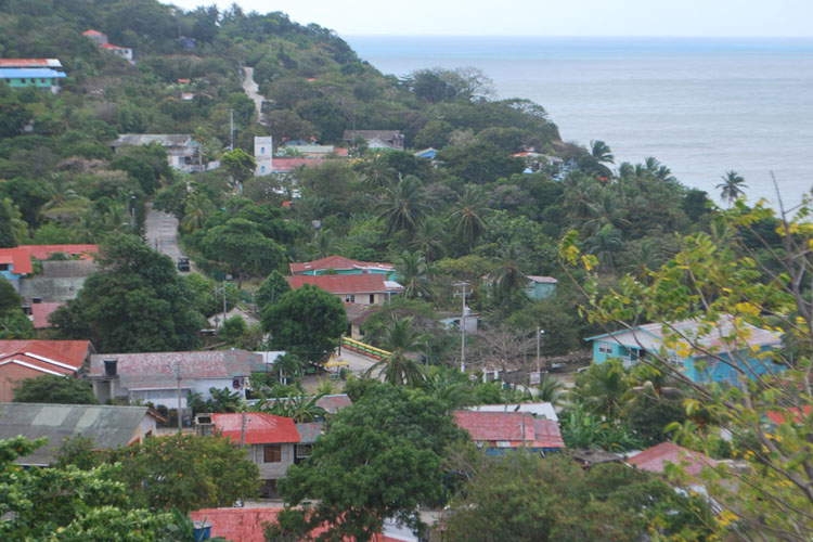The road through Lazy Hill. Following the resettlement of Providence by white Jamaicans and their slaves in about 1788, the villages of Town, Free Town, Lazy Hill, Southwest Bay, Bottom House, Smoothwater Bay and Rocky Point each developed a distinct identity based on the families that built them. 